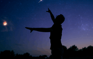 Man standing looking at the night sky